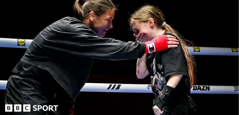 Boxer interacting with young girl in the ring