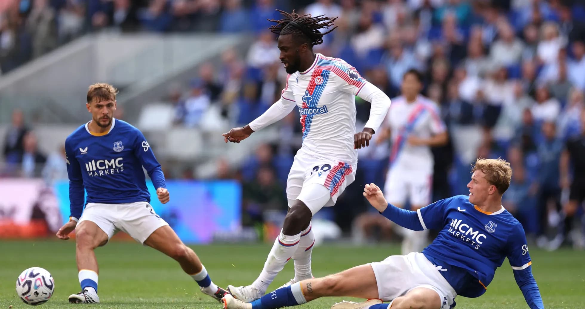 Player in white evading two defenders during match