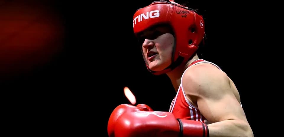 Boxer wearing red gear preparing for match