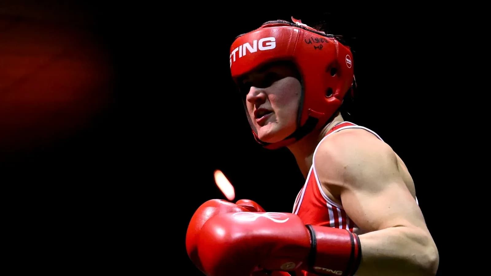Boxer wearing red gear preparing for match