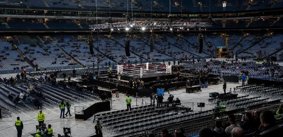 Boxing ring setup in large empty arena