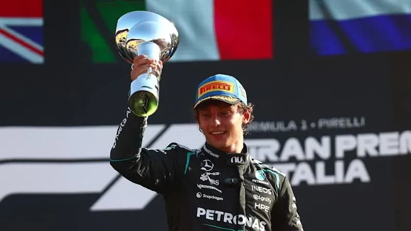 Driver celebrating with trophy at podium ceremony