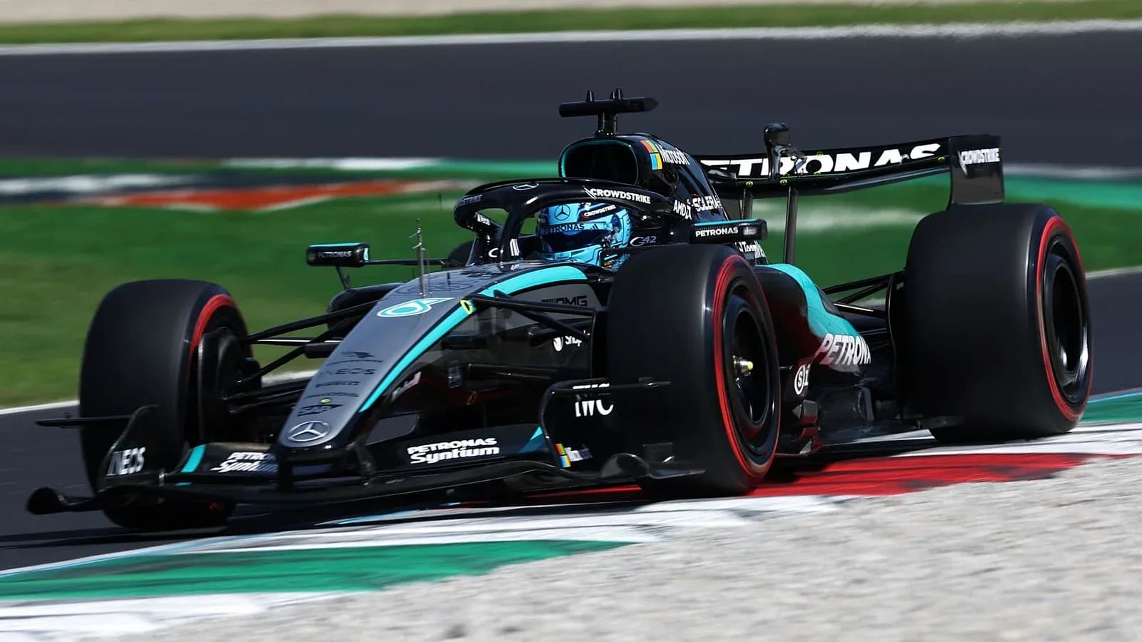 Mercedes F1 car driving on racetrack corner