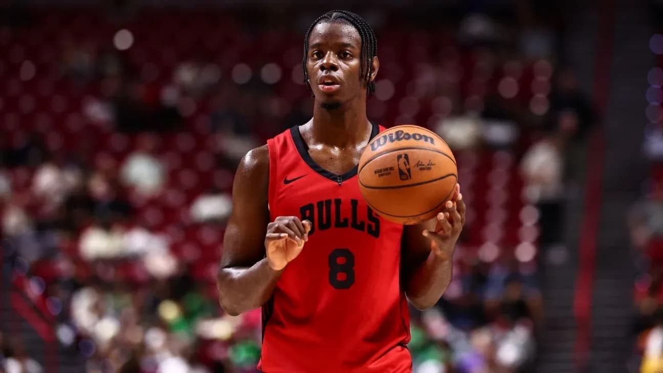 Player in Bulls jersey preparing to shoot basketball