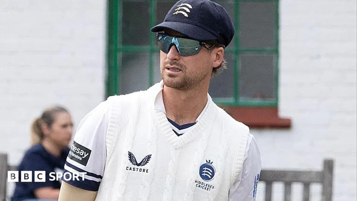 Cricketer wearing Middlesex kit and sunglasses