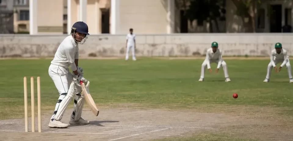 Batsman preparing to hit a ball in cricket match