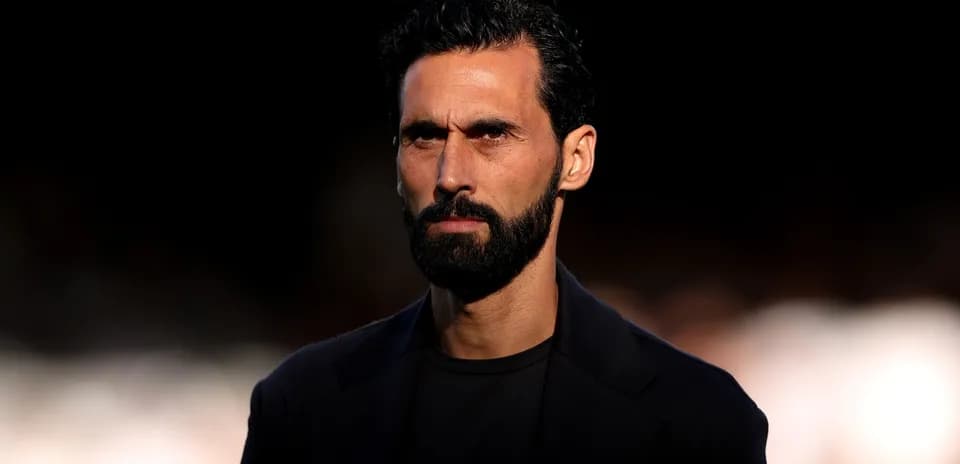Man with beard and serious expression on stage
