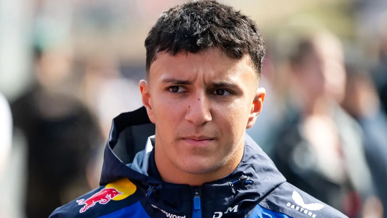 Driver wearing team jacket in paddock area