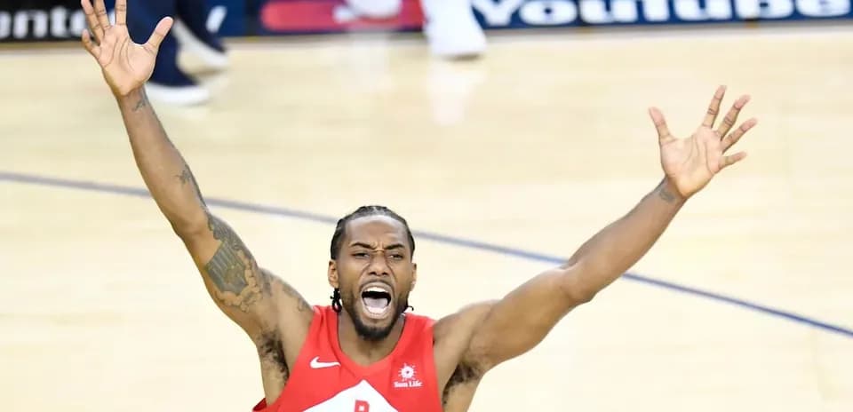 Player celebrating with arms raised on court