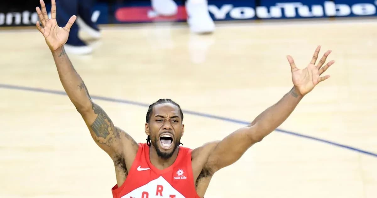 Player celebrating with arms raised on court