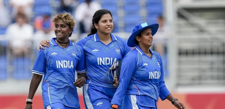 Three Indian female cricketers walking together