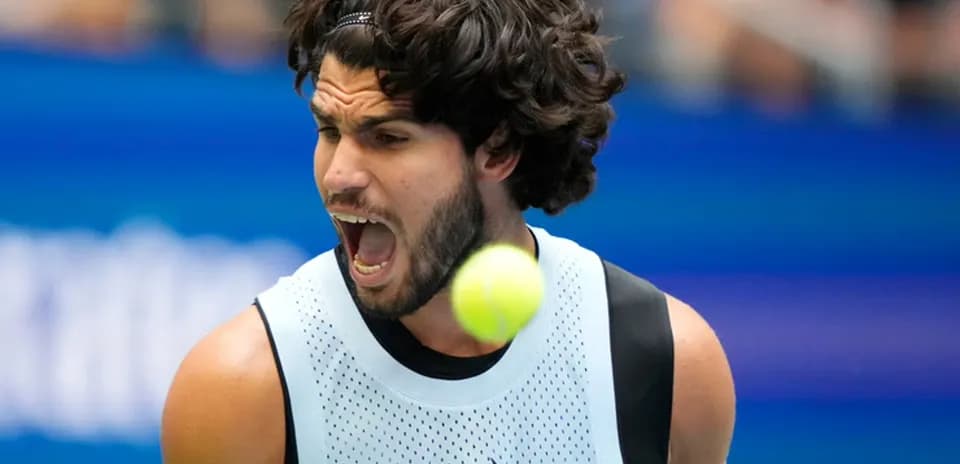 Player shouting while hitting a tennis ball