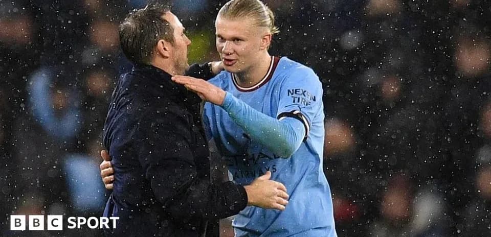 Player and coach sharing a moment on the pitch