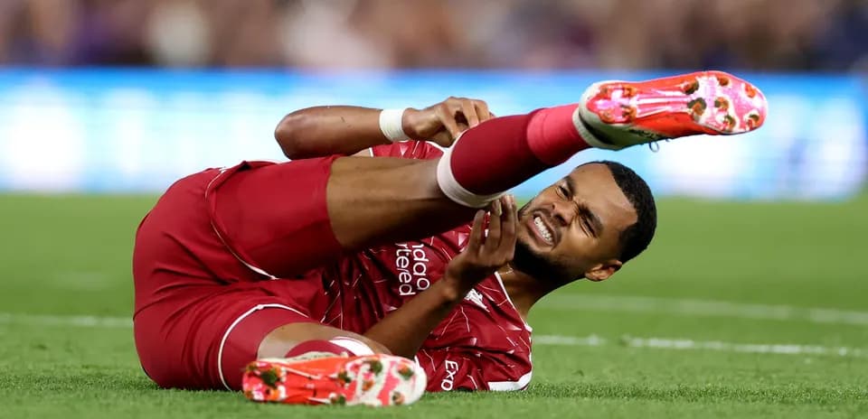 Player from Liverpool lying on the pitch injured