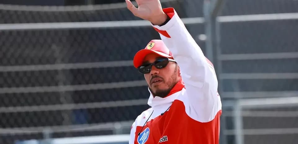 Driver waving during an event at racetrack