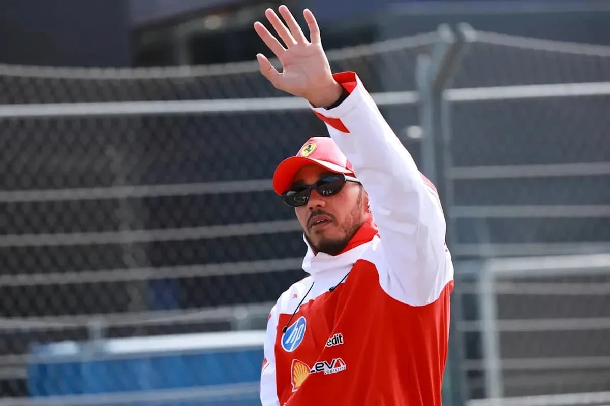 Driver waving during an event at racetrack