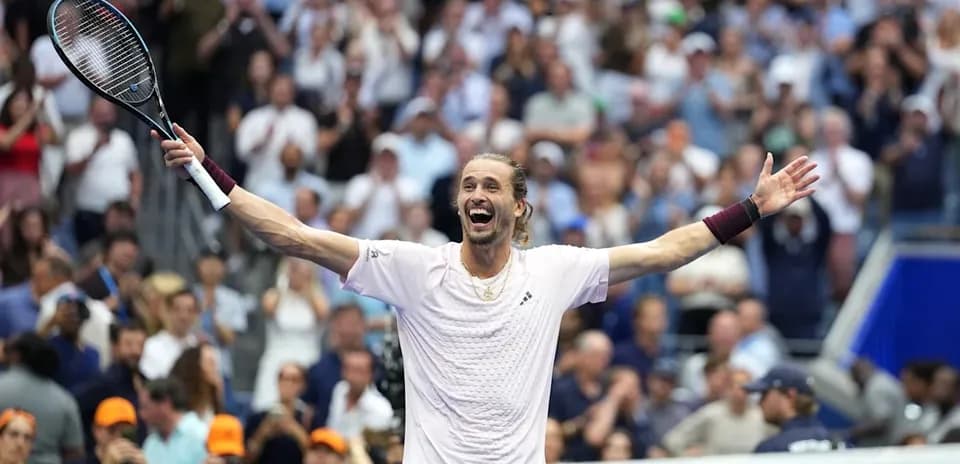 Tennis player celebrating victory with raised arms