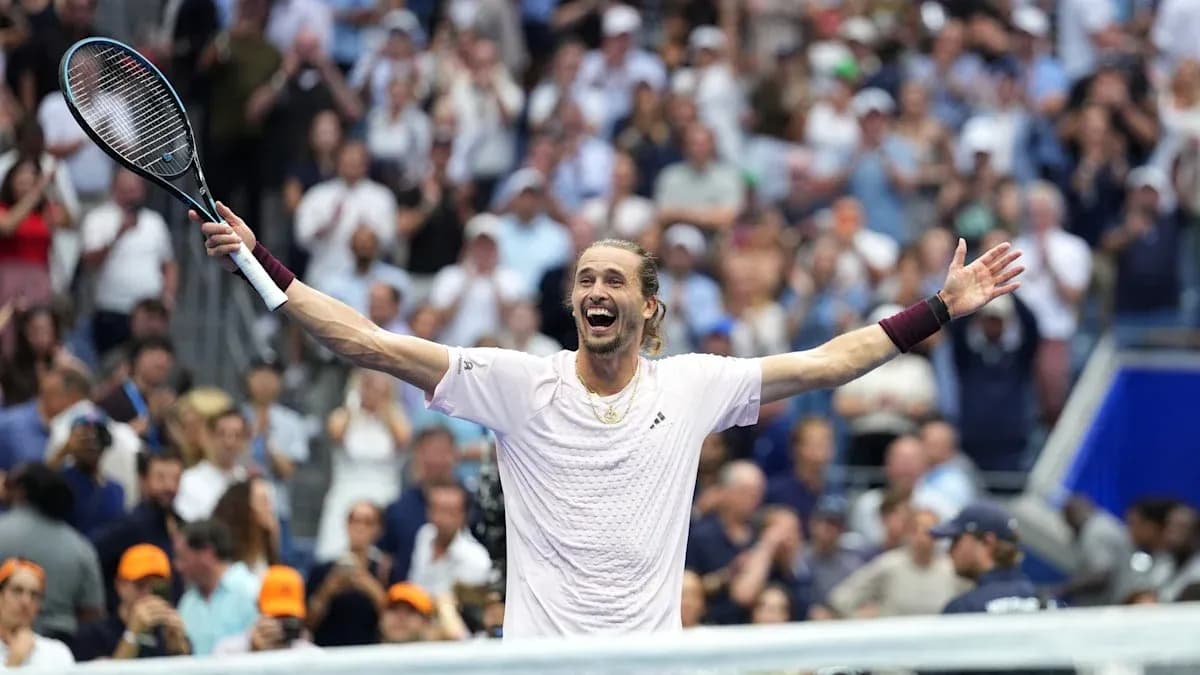 Tennis player celebrating victory with raised arms