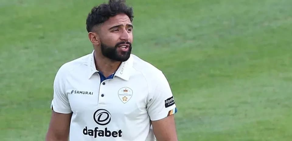 Cricketer wearing Derbyshire kit on field