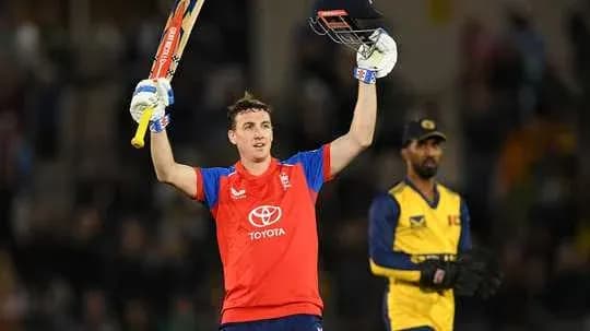 Batsman celebrating century with raised bat on field