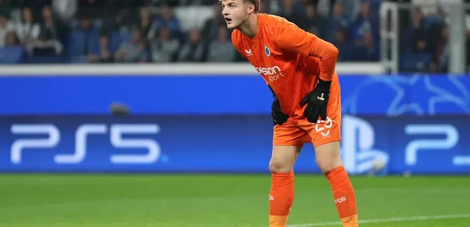 Goalkeeper in orange kit preparing for play