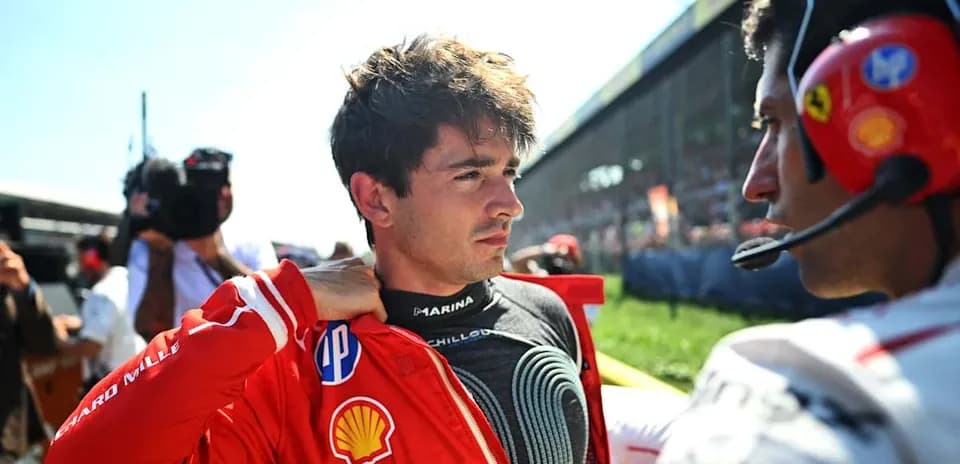 Driver preparing for race with team member nearby