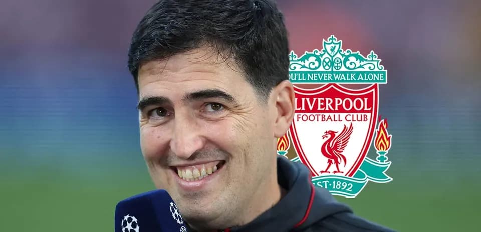 Man speaking into microphone with Liverpool logo behind