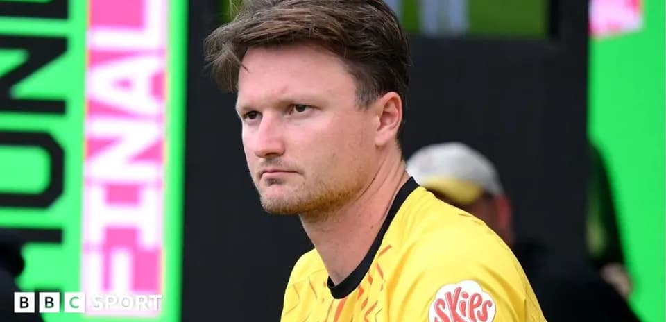 Player in yellow jersey sitting on bench