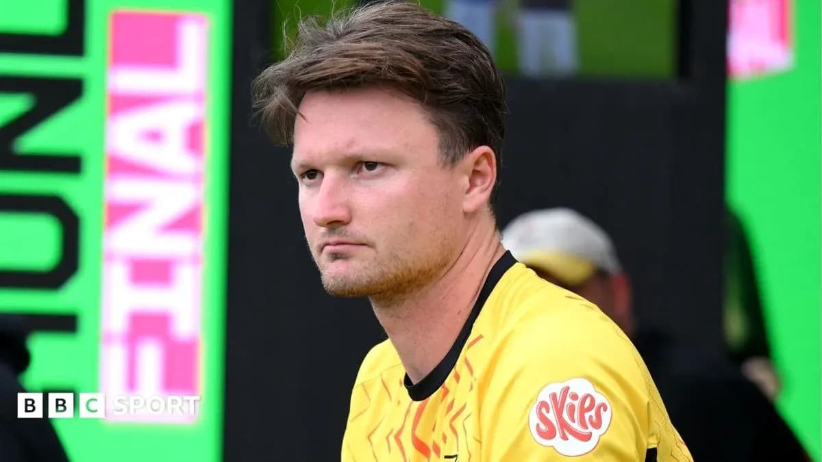 Player in yellow jersey sitting on bench