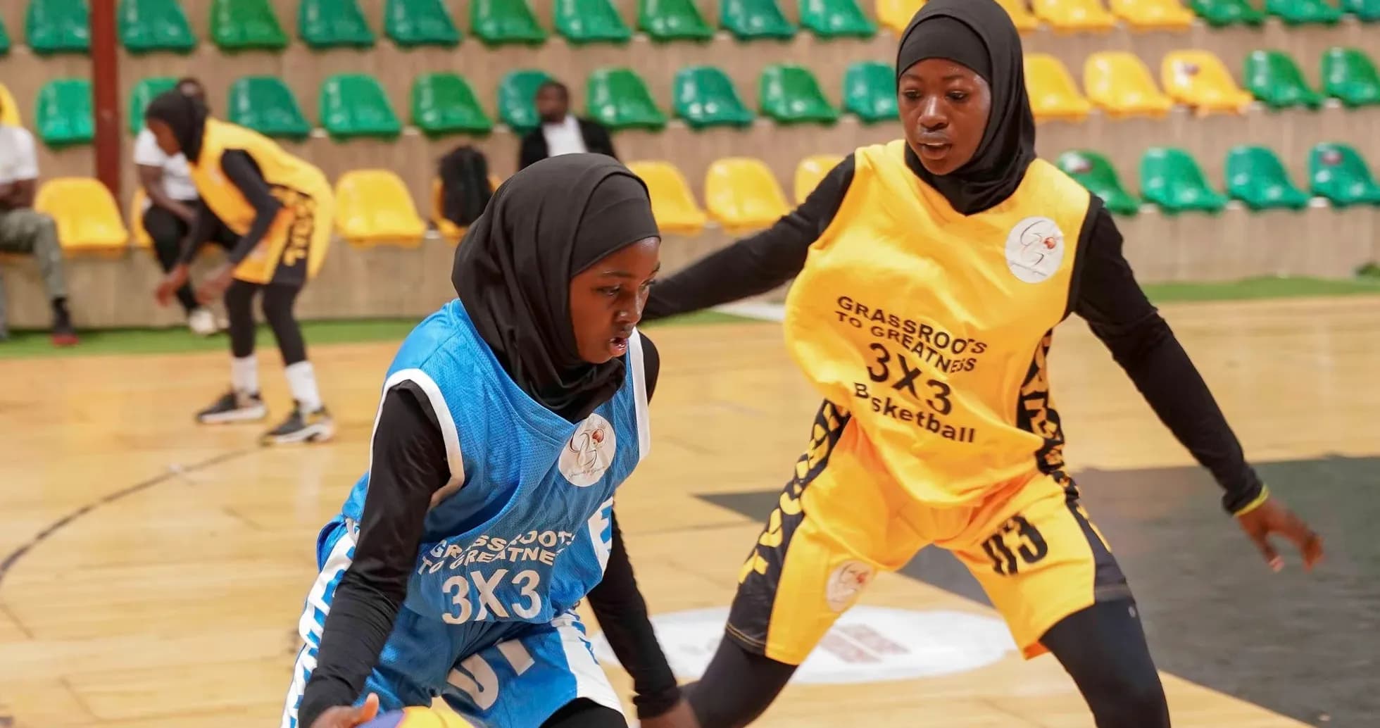 Two female players competing in 3x3 basketball match