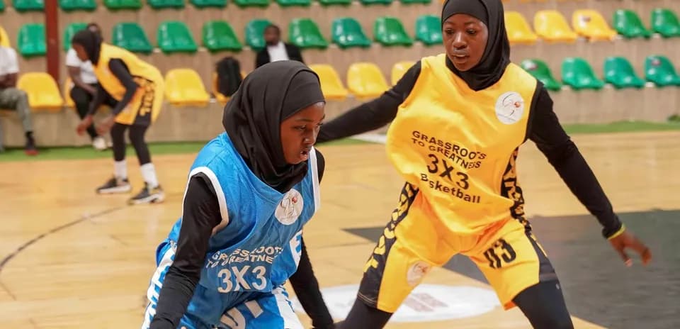 Two female players competing in 3x3 basketball match