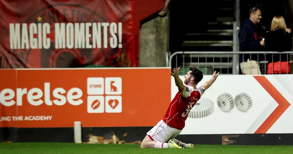 Player celebrating a goal in front of fans
