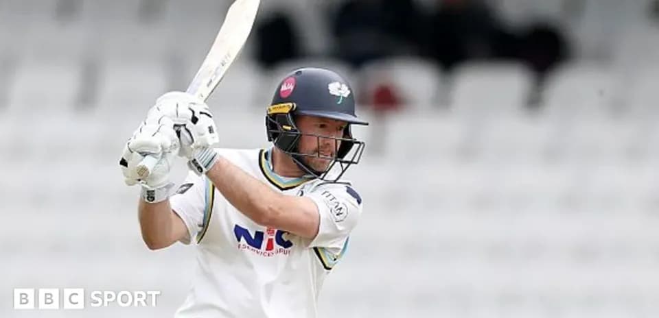 Batsman playing a shot during a cricket match