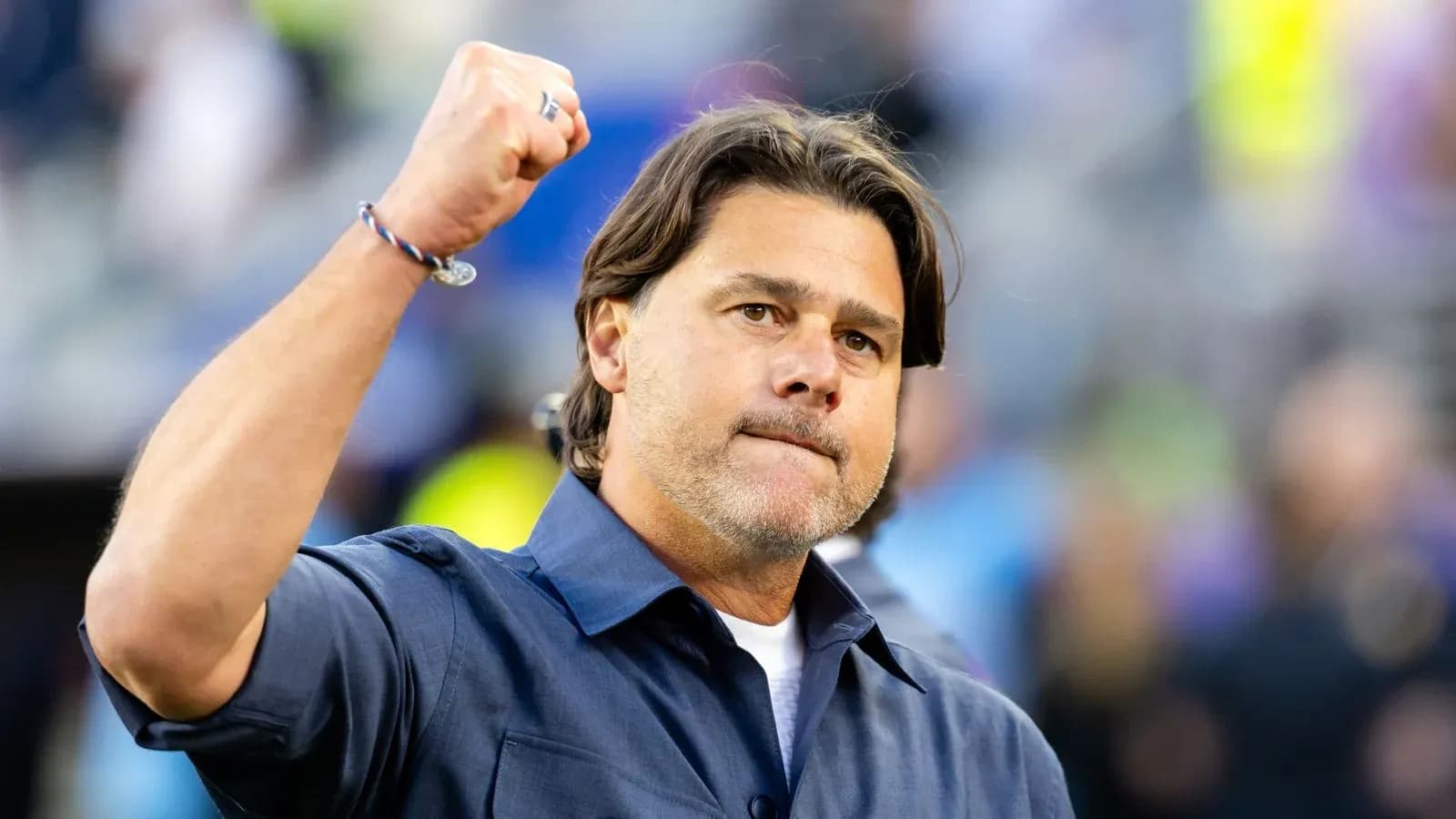 Coach celebrating with raised fist during match