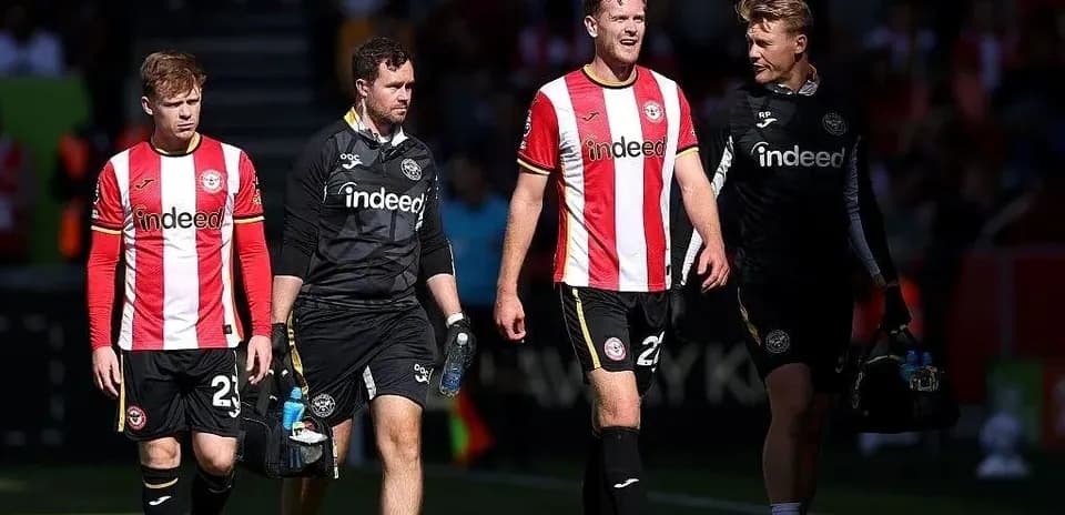 Brentford players and staff leaving the pitch