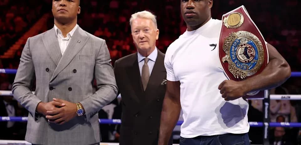 Two boxers and a promoter at a boxing event