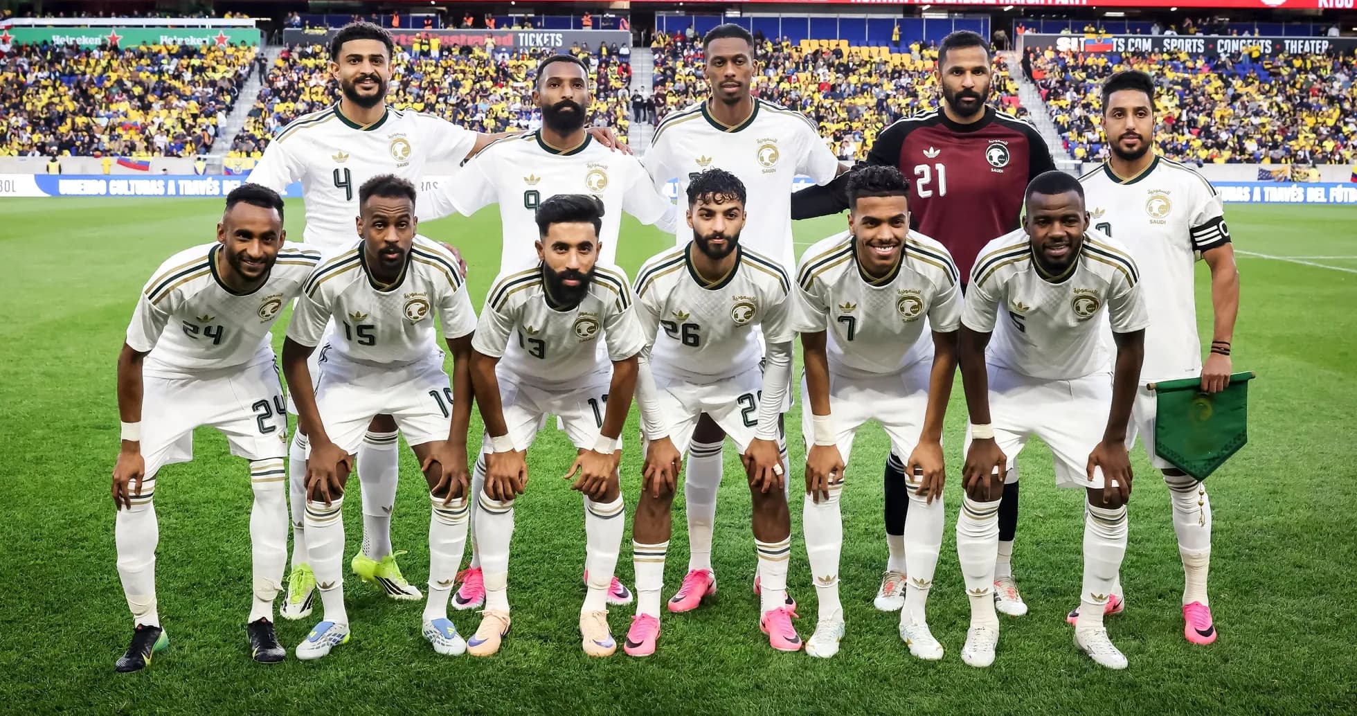 Soccer team posing for a group photo on field