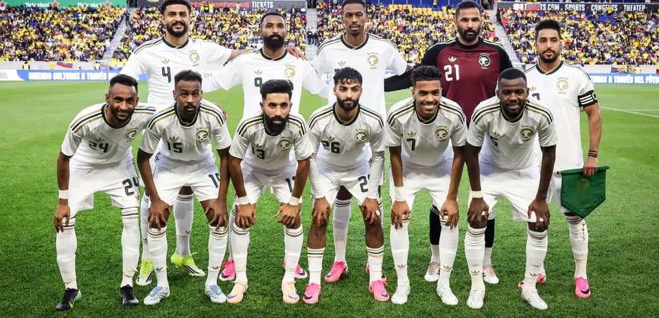 Soccer team posing for a group photo on field