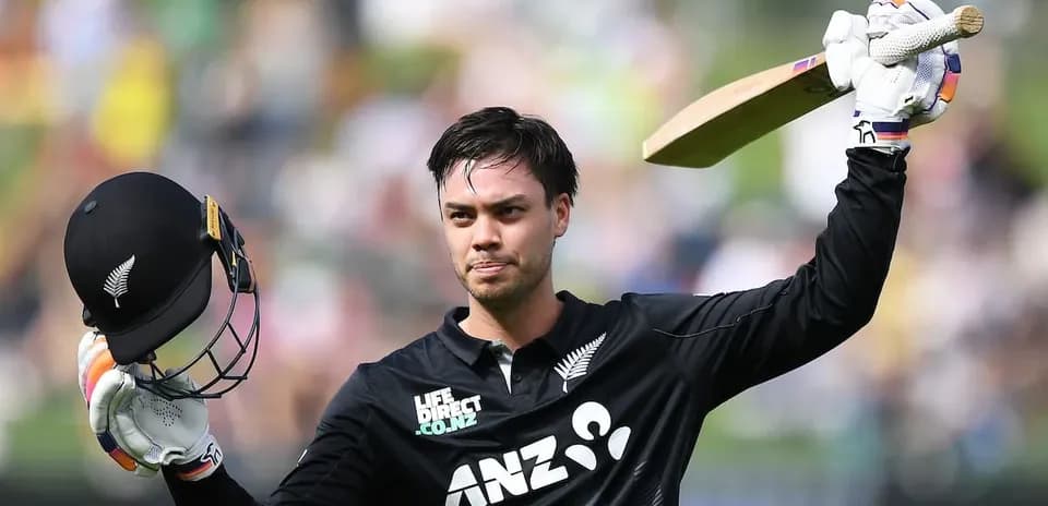 Cricketer celebrating with helmet and bat raised
