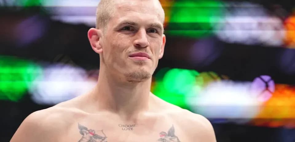 Fighter with tattoos posing in the octagon
