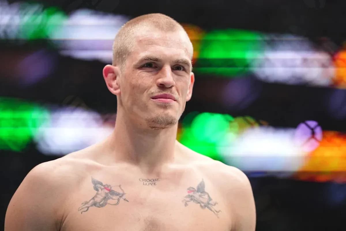 Fighter with tattoos posing in the octagon
