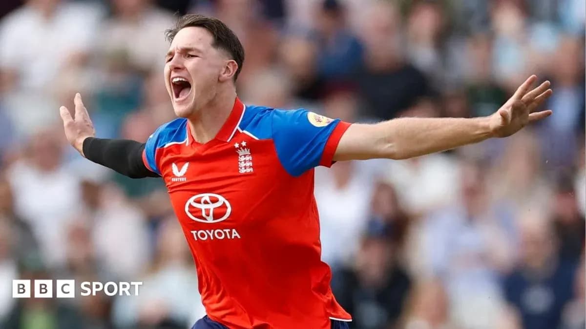 Cricketer celebrating a wicket in red England uniform