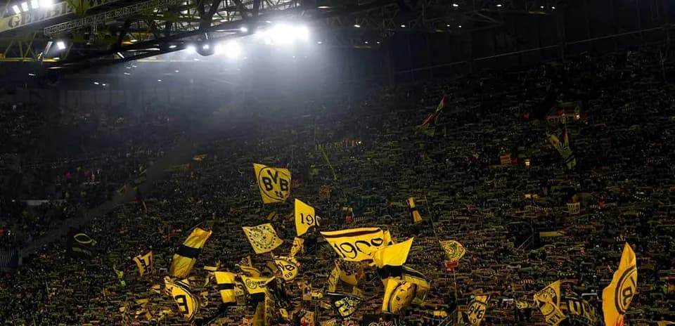 Crowd waving flags at Borussia Dortmund stadium