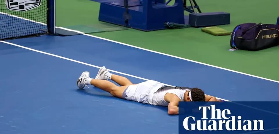 Player lying on tennis court after match loss