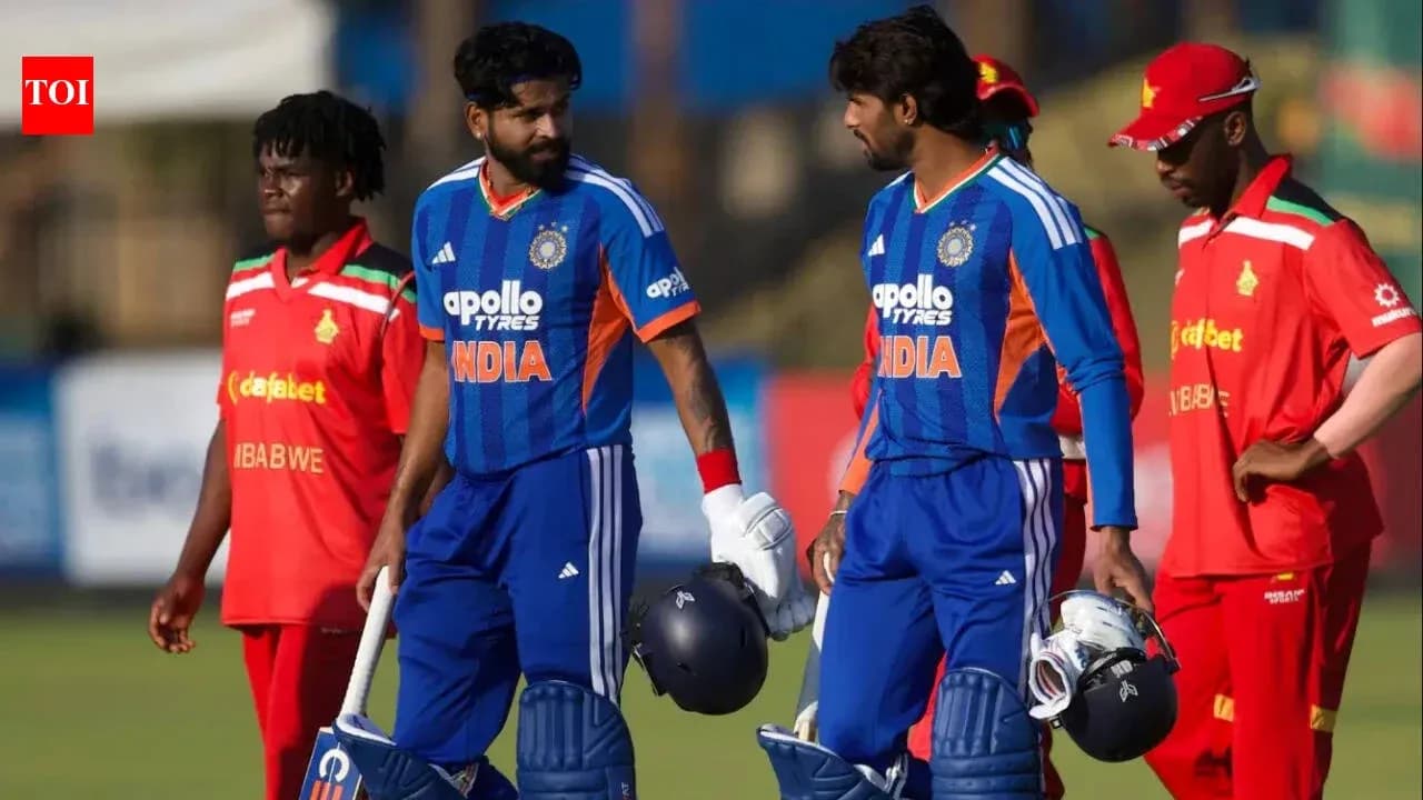 Two Indian cricketers walking off the field