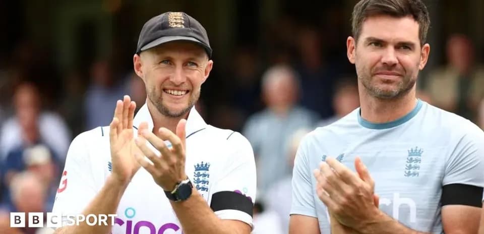 Two England cricketers applauding on the field