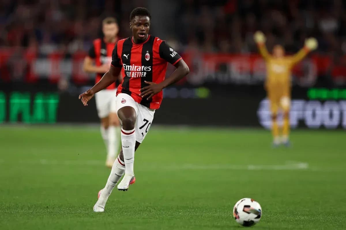 Player running with ball during match for AC Milan