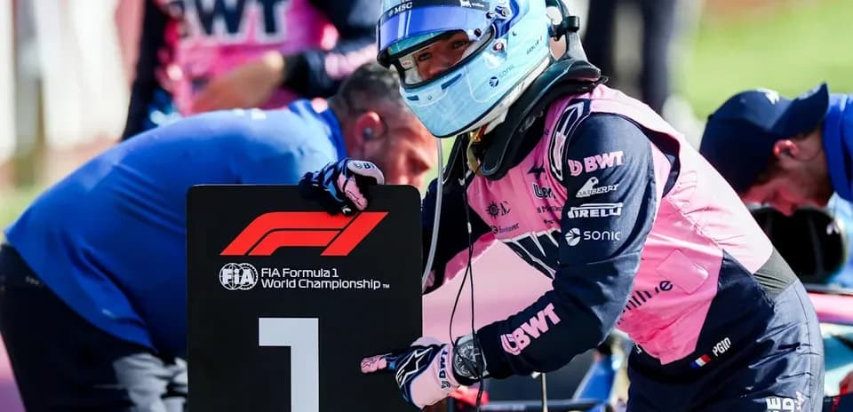Driver holding a number one sign during Formula 1 event