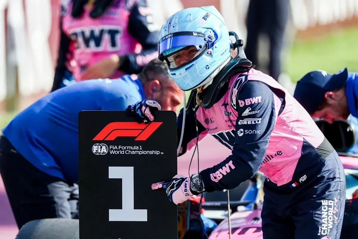 Driver holding a number one sign during Formula 1 event