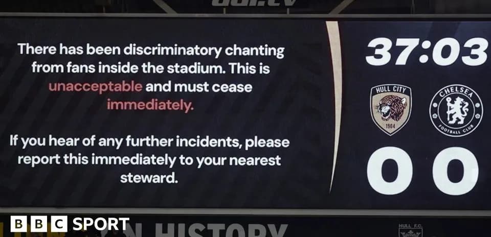 Stadium screen showing warning about discriminatory chanting